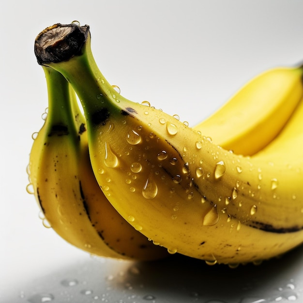 Three bananas with water droplets on them and one has the word banana on it