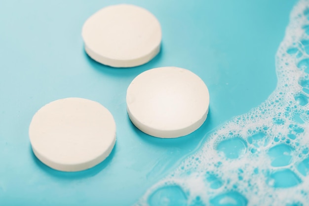 Three bars of round soap with foam