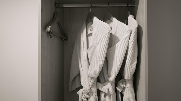 Фото Три халата висят на вешалке в шкафу в гостиничном номере