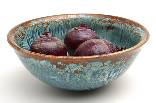 Three beets in blue wooden bowl on white