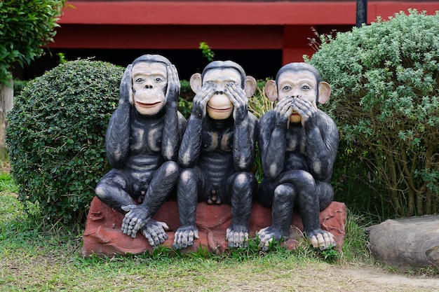 Three black monkeys statue closes eye mouth ear