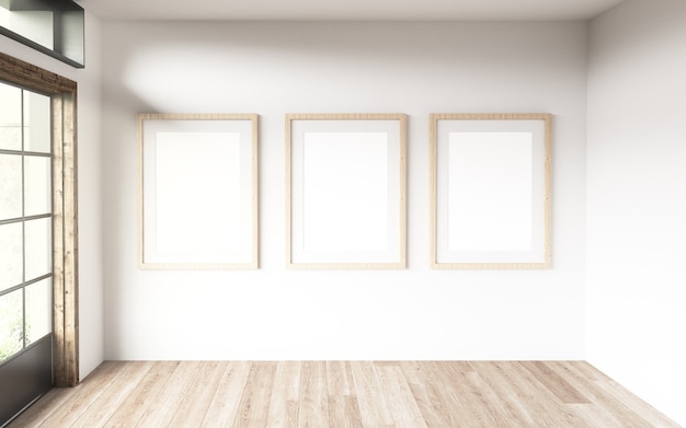 Three blanck frames in a room with large windows. 