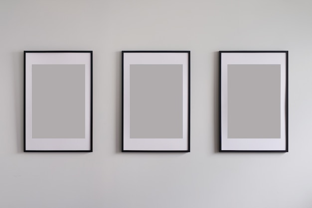 Three blank frames on wall.