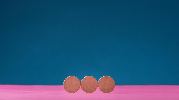 Three blank wooden cut circles placed in a row