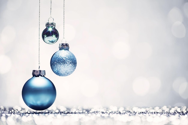 Three blue Christmas baubles with white background