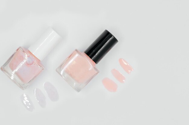 Three bottles of nail polish on a white background