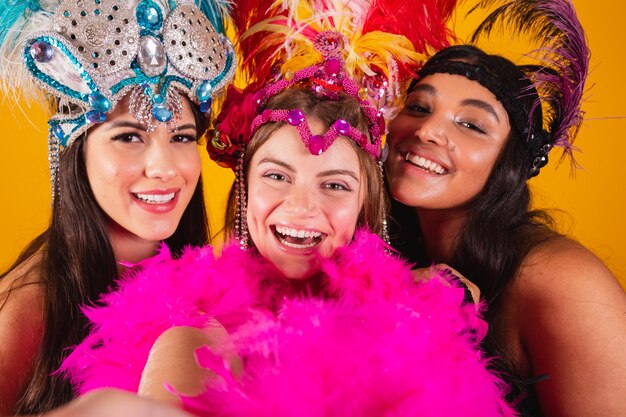 Premium Photo | Three brazilian female friends with queen clothes from ...