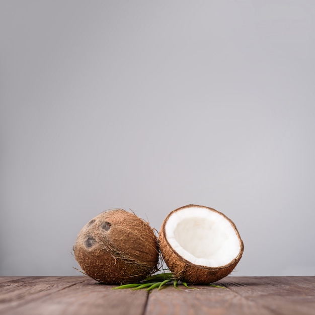 Three brown coconut on old wooden board