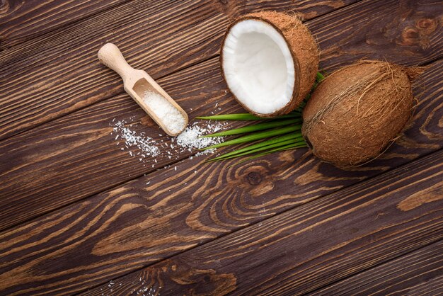 Three brown coconut on old wooden board