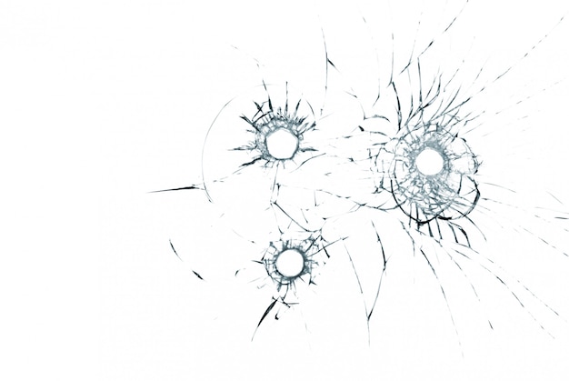 Three bullet holes in glass close up on white background