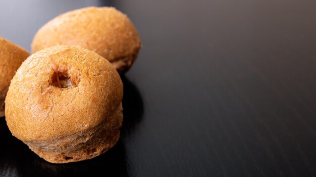 Three buns on a wooden table closeup