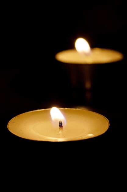 Three burning candles on the table closeup