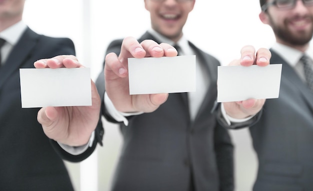 Three business partners showing their business card form