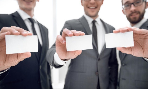 Three business partners showing their business card form