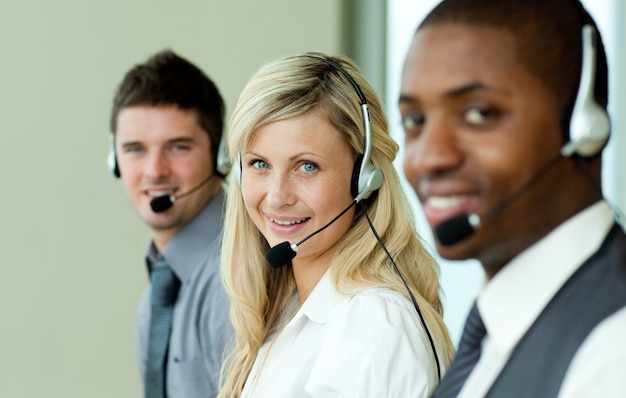 Three business people working with headsets