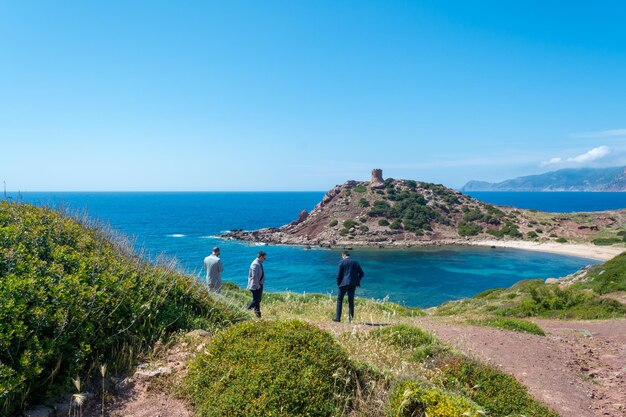 Three businessmen stare at the coast