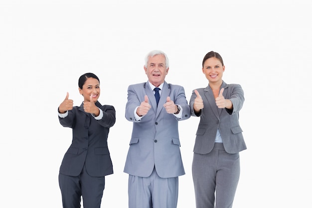 Three businesspeople giving thumbs up