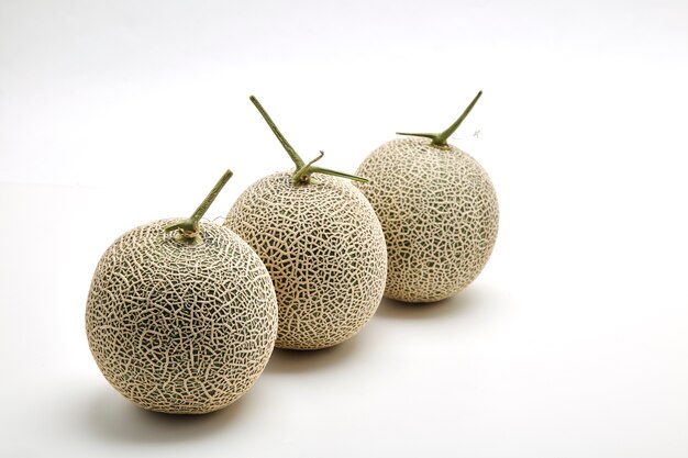 Three cantaloupe melon on white