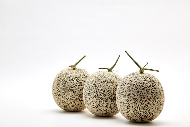 Photo three cantaloupe melon on white