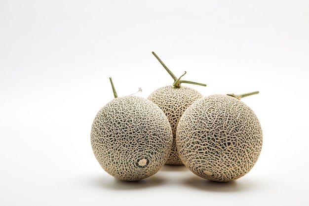 Three cantaloupe melon on white