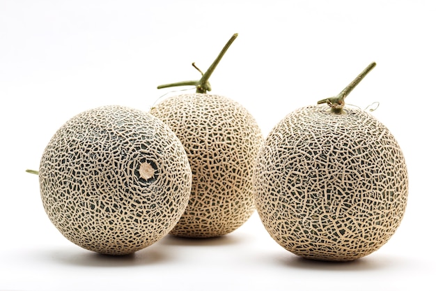 Three cantaloupe melon on white