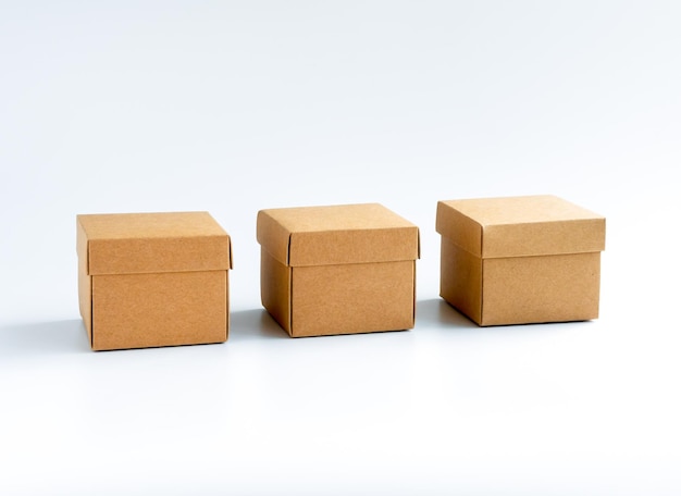 Three cardboard boxes isolated on white background Carton gift box presents Square kraft paper box with lid on top Delivery parcel packaging with online shopping and shipping concepts