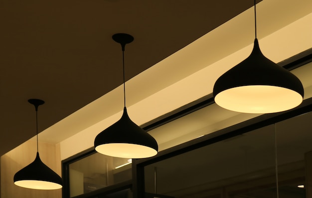 Photo three ceiling pendant lampshades lighting up the warm light