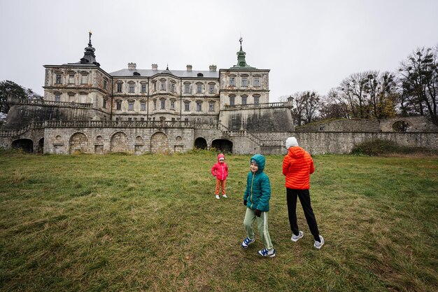 Three children visit Pidhirtsi Castle Lviv region Ukraine Family tourist