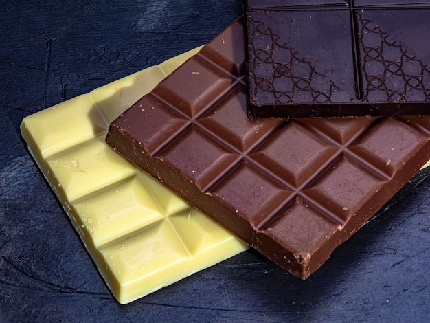 Three chocolates on dark background