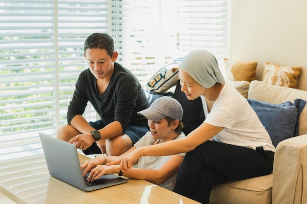 Three colleagues working on laptop at home