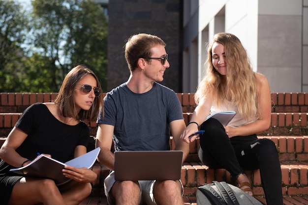 Three college students working together in a project