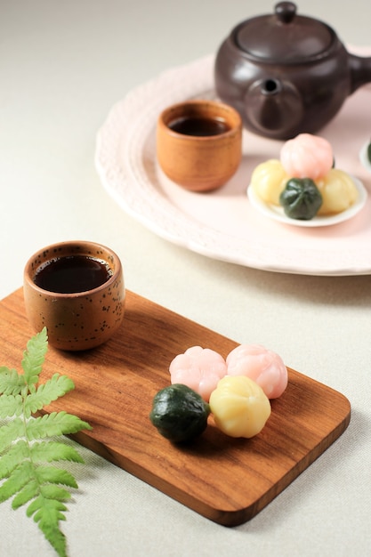 Photo three color kkultteok is ball shaped rice cake filled with honey and sesame syrup, korean traditional cake for chuseok day