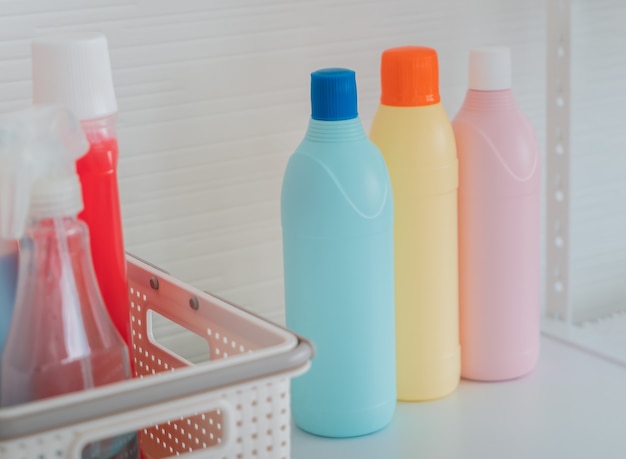 Three color set of washing and cleaning liquid bottles on a white shelf for product mock up.