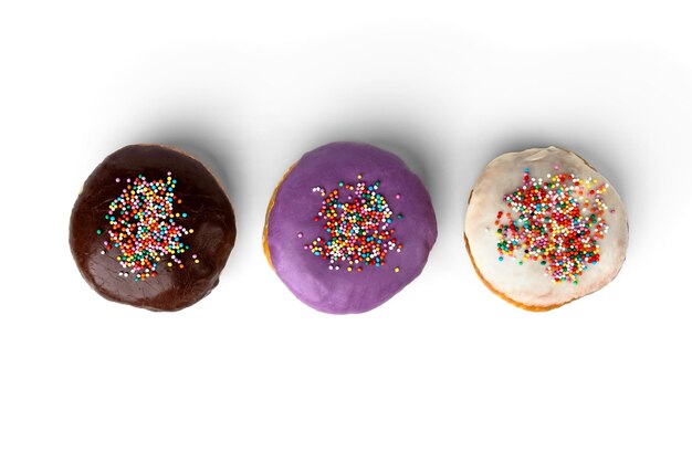 Three colorful donuts with glaze isolated on white background.