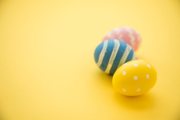 Three colourful Easter eggs on table