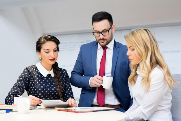 Three concerned colleagues are trying to solve a problem together.