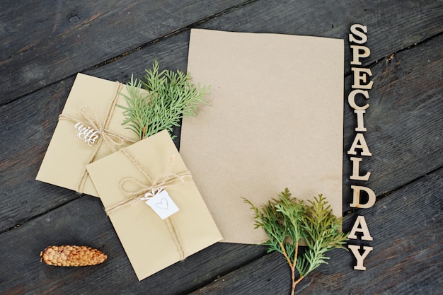 Three craft envelopes and a piece of craft paper. Place for your text and message. Handmade gift wrap. The lettering is the inscription "special day".