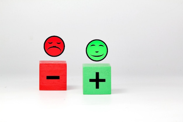 Photo three cubes with a plus sign and a smiley face face emotional customer service customer review