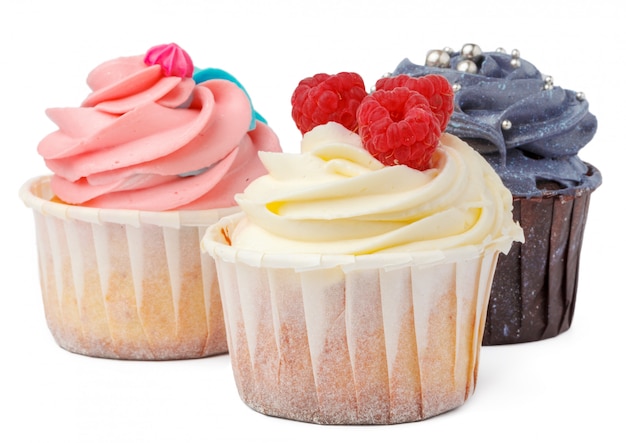 Three cupcakes close up isolated on white background