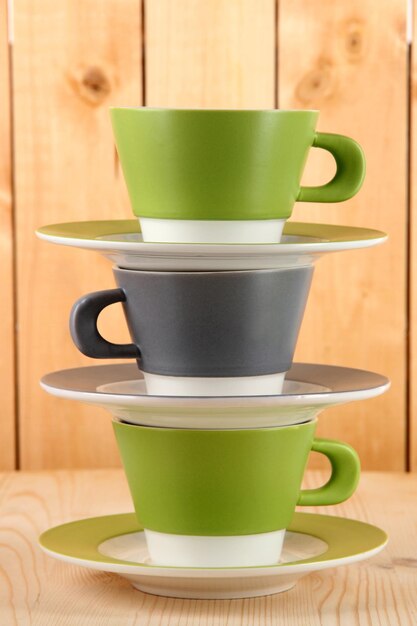 Three cups on wooden background