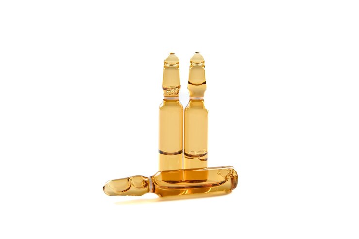 Three dark glass ampoules with medicine isolated on a white background