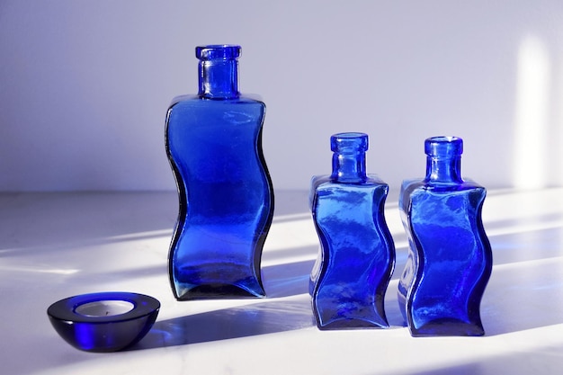 Three decorative, blue bottles in sunlight.Decor.