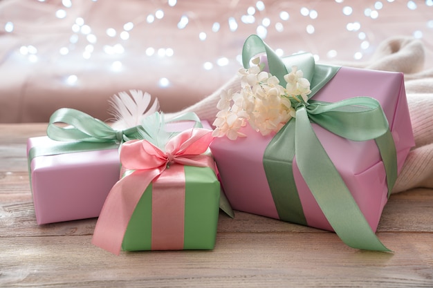 Three delicate decorated gift boxes on a light background. Side view, with space to copy.