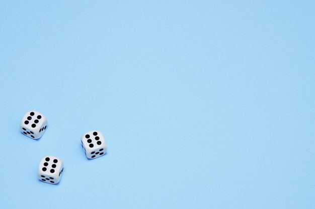 Three dice with the same dropped out numbers lie on a blue background