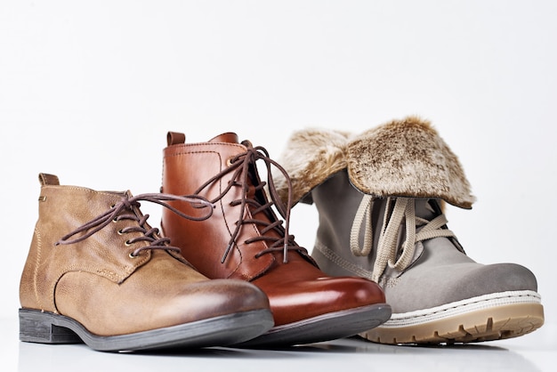 Three different leather womens boots on white background isolated