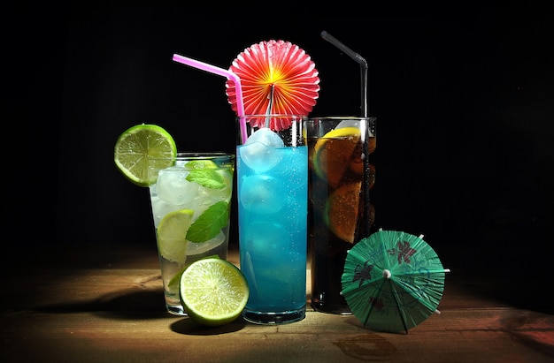 Three different, refreshing cocktails on wooden table