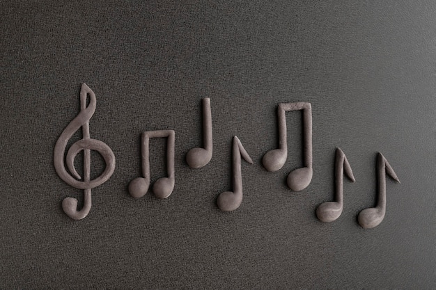 Three-dimensional notes and treble clef on black background.\
musical notation. music symbol.