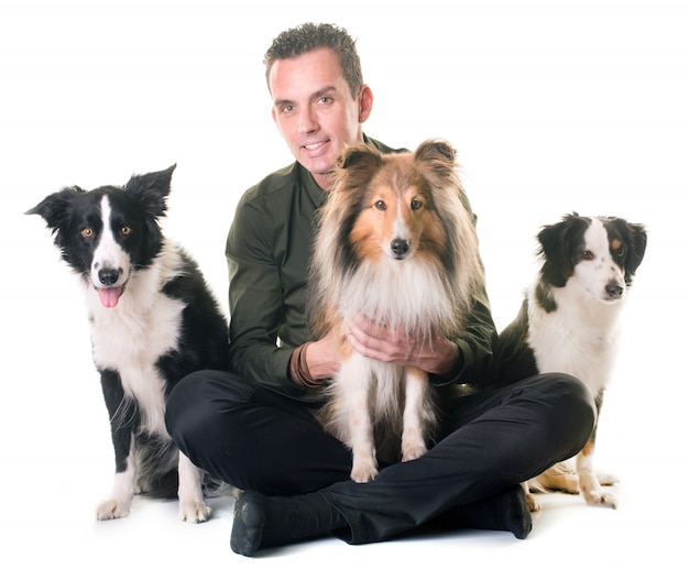 three dogs and man