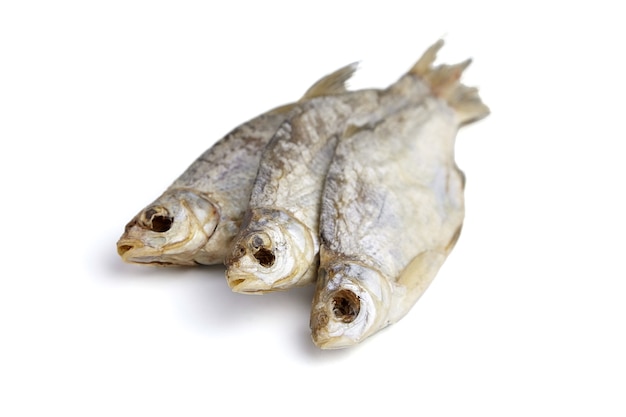 Three dry fish closeup isolated on white