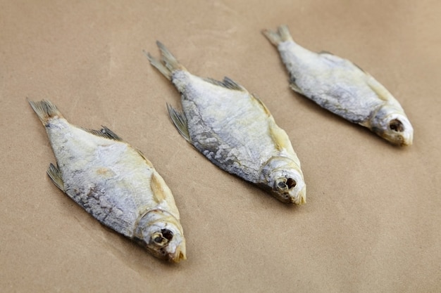 Three dry fish on parchment paper